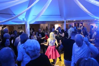 Performers centre of the dancefloor with guests all around