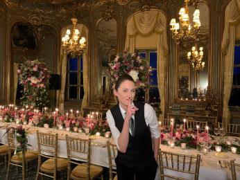 Female surprise singer posing in a gorgeously decorated room ready for guests to arrive