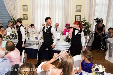Singing waitresses and waiter performing during wedding breakfast