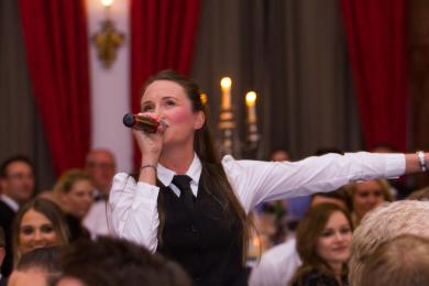 All eyes on our singing waitress as she provides surprise entertainment at a corporate event during the meal