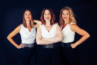 Posed photo of SOS Party female trio function band in black and white jumpsuits
