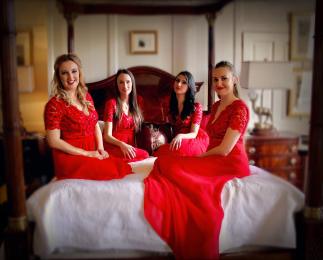 The Noelles UK four piece line-up chilling on a four poster bed before the show
